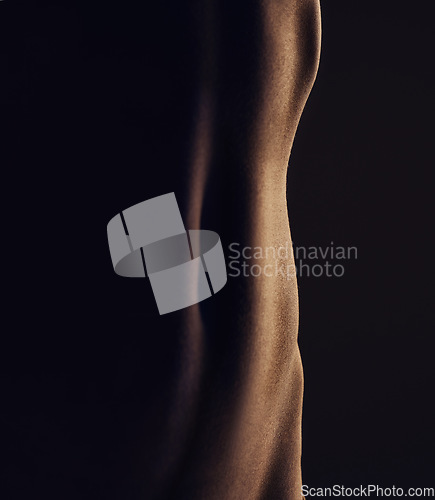 Image of Nude, stomach and silhouette, woman and closeup, sexy and dark aesthetic, art with skin and sensual on black background. Body, beauty and creative with seduction, desire and naked female in studio