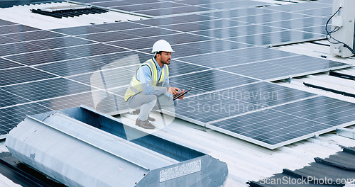 Image of Engineer or contractor measuring solar panels on a roof of a building. Engineering technician or electrician installing alternative clean energy equipment and holding a tablet to record measurements