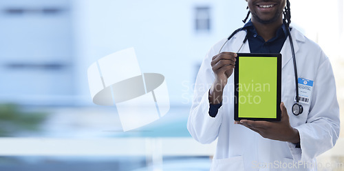 Image of Doctor, happy man and hands with green screen on tablet in telehealth, healthcare or life insurance at hospital. Hand of male medical professional holding technology with mockup or copy space display