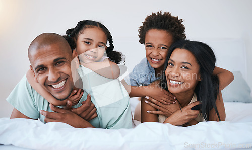 Image of Portrait, family and smile in home bedroom, bonding and relaxing or lying together. Bed, happiness and children with mother and father or parents enjoying quality time, having fun and care in house.