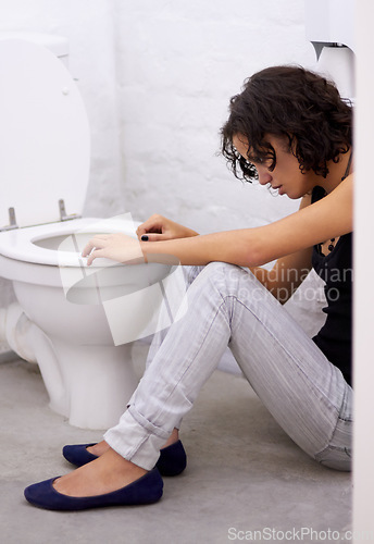 Image of Bathroom, sick and woman on a floor suffering from anorexia, depression or anxiety. Stress, toilet and female with body dysmorphia, bulimia or an eating disorder, nausea and mental health problem