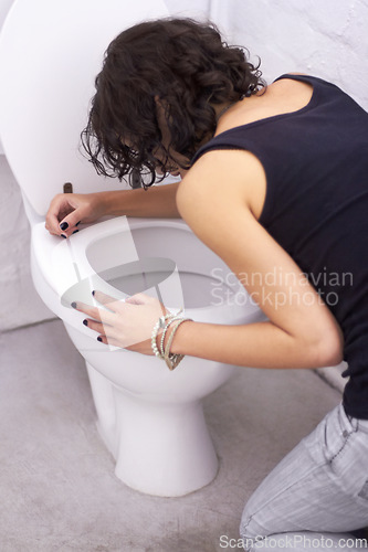 Image of Woman, toilet and sick with bulimia or anorexia, problem and anxious need to control weight with vomiting. Girl, bathroom and eating disorder habit or puke, nausea and hurt stomach after meal