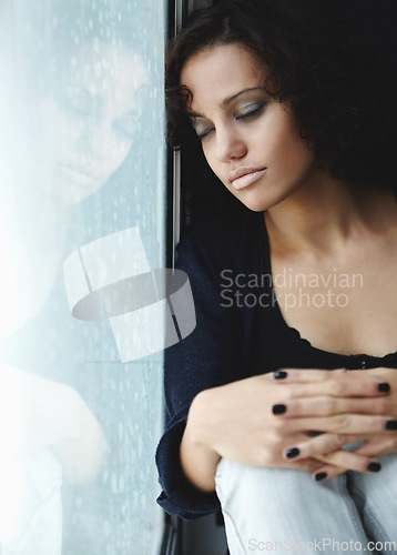 Image of Sad, rain and crying with woman by window for depression, tired and lonely. Anxiety, mental health and exhausted with female thinking at home for broken heart, disappointed and fear mockup