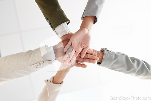 Image of Business people, hands together and support with team solidarity low angle and motivation in office. Success, collaboration and corporate group with teamwork, professional community and workforce