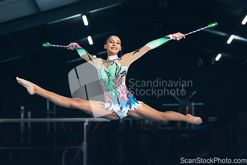 Image of Performance, gymnastics and female jumping with a ribbon in a professional gym or arena for training. Sports, routine and woman athlete gymnast doing a trick practicing for competition or challenge.