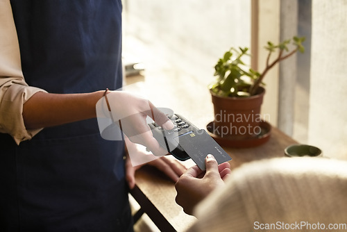 Image of Hand, credit card and pos terminal in a coffee shop for payment by a customer to a waitress for service. Finance, bill and nfc with a person paying using wireless technology in a cafe or restaurant