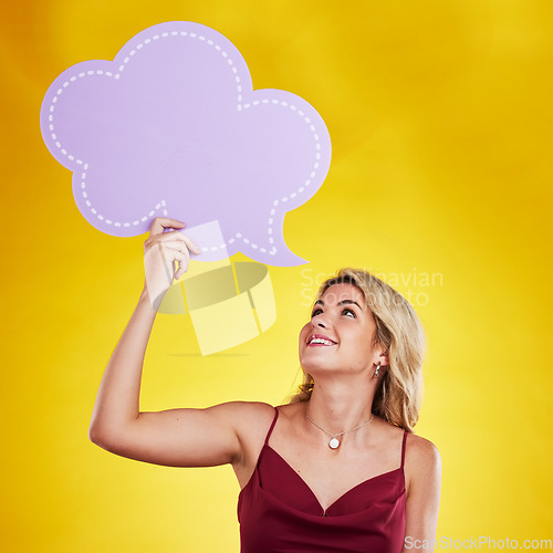 Image of Smile, looking and woman with speech bubble in studio isolated on a yellow background. Poster, word cloud and happy female person holding advertising banner for marketing, opinion or social media.