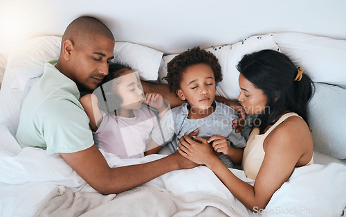 Image of Family, sleeping and relax in bed above for free time, weekend or holiday morning at home. Top view of tired or exhausted mother, father and children or kids relaxing or asleep together in bedroom