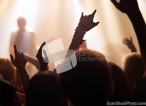 Image of Crowd, rock and people at a concert for a band, performance and event at night. Party, celebration and group of fans at a music festival for a show, live entertainment and watching a musician