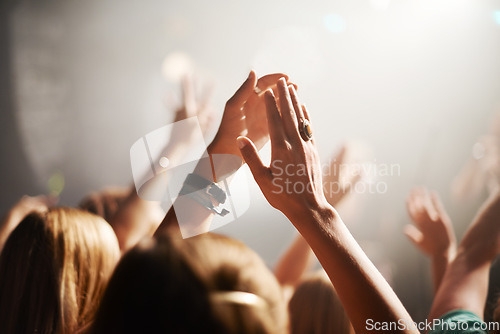 Image of Clapping crowd, party and people at a concert for celebration, performance and watching a band. Energy, audience support and fans applause at a music festival, club or dancing rave show at night