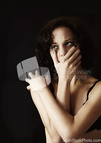 Image of Depression, anorexia and alone with a woman on a dark background in studio suffering from an eating disorder. Mental health, bulimia and stress with an unhealthy young female person feeling anxiety