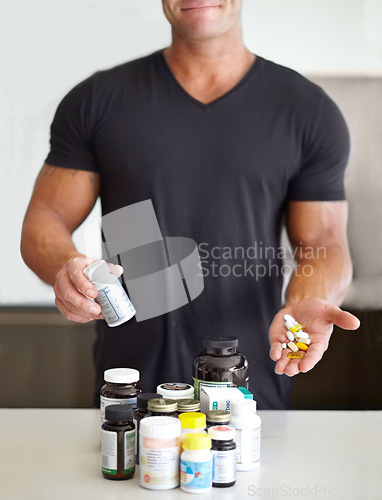 Image of Healthy, showing and man with pills for training, fitness energy and muscle gain. Diet, drugs and an athlete taking a supplement for sports, body builder protein and drugs for exercise at home