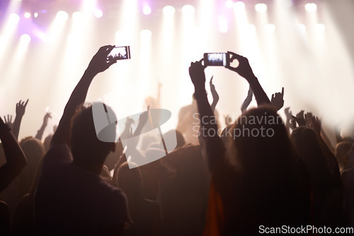Image of Music, festival and hands of audience with phone for pictures, celebration and enjoying night, concert or event. Party, people and performance with excited fans showing support, passion and recording