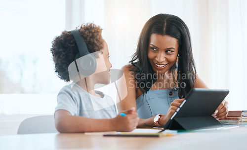 Image of Elearning, happy and a mother and child with a tablet for education, studying and online class. Smile, teaching and a mom helping a boy kid with homework with technology during homeschooling