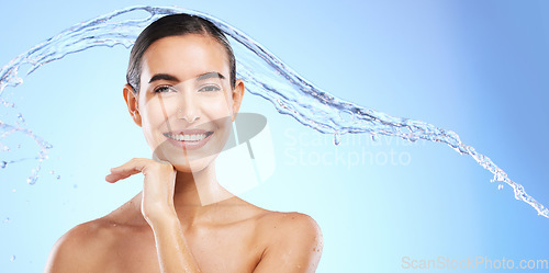 Image of Water splash, skincare portrait or happy woman with smile or smiling female model face on studio background. Dermatology cosmetics or beautiful girl with facial treatment, beauty or glowing results