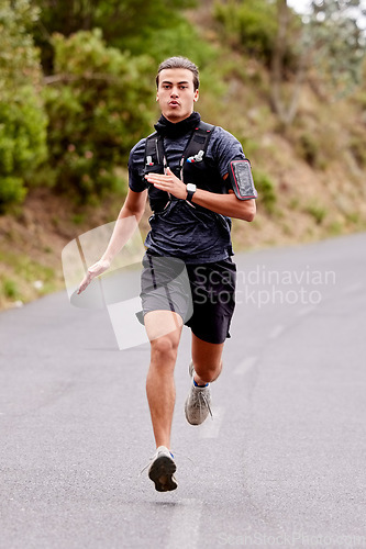 Image of Running, fitness and portrait of man runner for outdoor training or exercise goals, challenge and sports health in nature. Young, fast and speed of serious athlete in cardio workout on road or street