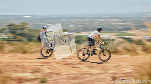 Image of Mountain bike, men and race with speed, dirt and nature in summer with wheelie, extreme sport and motion blur. Friends, bicycle and outdoor challenge for fast workout, training and exercise in summer