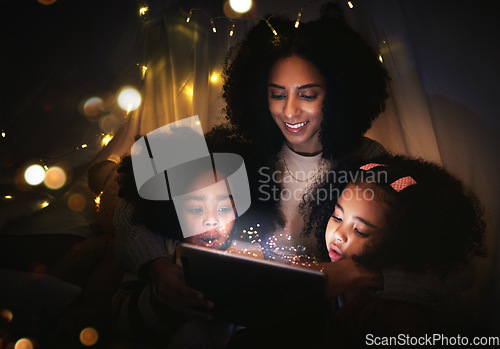 Image of Tablet, night a mother reading to her kids in a tent while camping in the bedroom of their home together. Black family, story or children with a woman storytelling to her kids at bedtime for bonding
