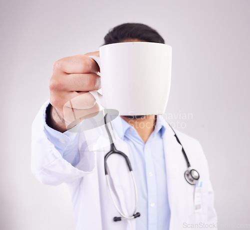 Image of Hand, coffee and doctor in studio for break, relax and morning routine against grey background. Healthcare, tea and man with drink, beverage and cup while working at hospital or clinic isolated