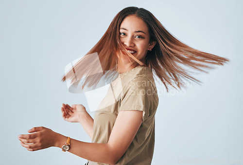 Image of Portrait, beauty and hair with a woman in studio on a gray background for keratin treatment or haircare. Salon, shampoo and hairstyle with an attractive young female posing to promote natural care