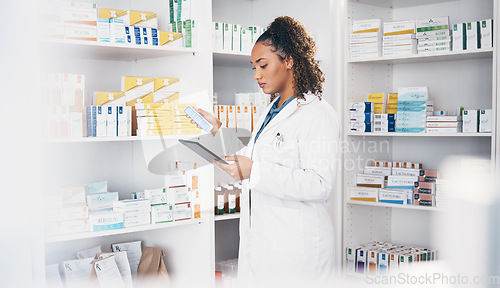 Image of Tablet, stock and medication with a woman in a pharmacy to fill an online order of prescription treatment. Healthcare, product or insurance with a female pharmacist working as a medicine professional