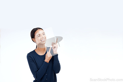 Image of Studio mock up, portrait or happy woman pointing at sales promotion, advertising copy space or discount deal mockup. Brand commercial, marketing or presentation gesture for female on white background