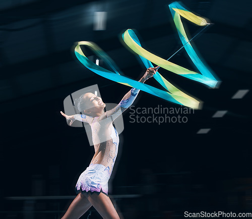 Image of Ribbon gymnastics, woman and smile in motion blur of dancer, talent show and competition in dark arena. Happy female athlete, rhythmic movement and dancing for action, creative sports and performance