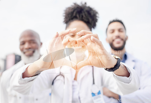 Image of Heart hand, happy and portrait of doctors in the city for healthcare, medical attention and care. Smile, medicine and hospital workers showing love with emoji hands for professional nursing as a team