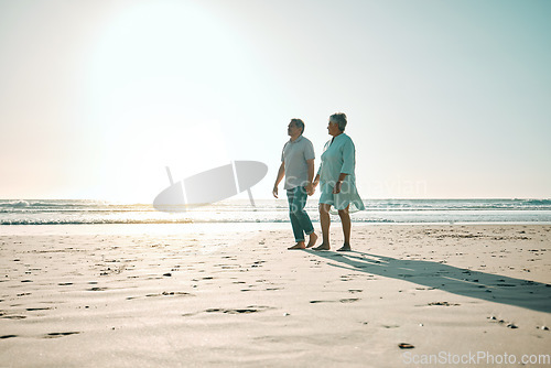 Image of Sunset, mockup and an old couple walking on the beach, holding hands during a romantic date together. Love, nature or bonding with a senior man and woman taking a walk on the coast during summer