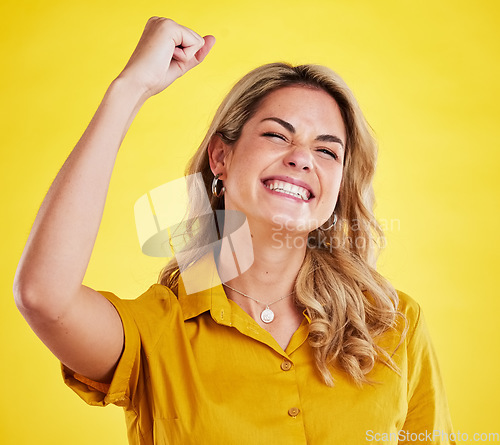 Image of Woman, fist celebration and happy in studio for winning, goals and success for achievement by yellow background. Girl, excited and winner with bonus, profit and prize from competition by backdrop