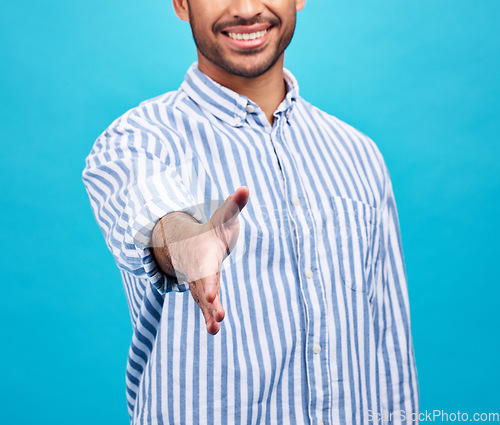 Image of Handshake, interview and hand of businessman on blue background for thank you, welcome and deal. Recruitment, hiring sign and male person shaking hands for opportunity, agreement or studio onboarding