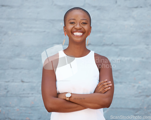 Image of Happy, brick wall and portrait of a black woman with arms crossed, pride and smiling with confidence. Smile, confident and a young African girl standing looking proud, motivated and empowered