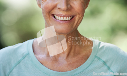 Image of Smile, teeth and closeup with a senior woman outdoor in nature feeling happy, positive or carefree. Mouth, cheerful and dental with a mature female smiling happily outside in a garden during summer