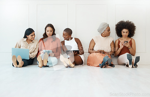 Image of Group, business and women on the floor, technology or focus for connection, social media or planning. Female employees, coworkers or staff on ground against a wall, office or device for data analysis