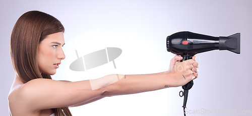 Image of Hair care, dryer and woman with a styling product isolated on a white background in studio. Salon, beauty and a model with a cosmetic tool from a hairdresser for a hairstyle as a weapon on a banner