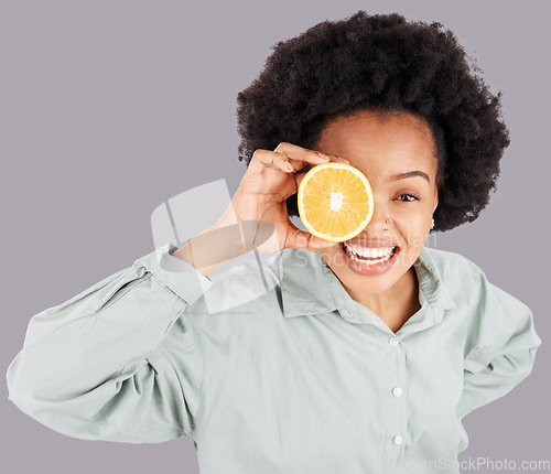 Image of Portrait, orange and black woman smile with fruits in studio isolated on a gray background. Food, top view and happiness of person with vitamin c, nutrition or healthy diet, citrus or vegan detox.