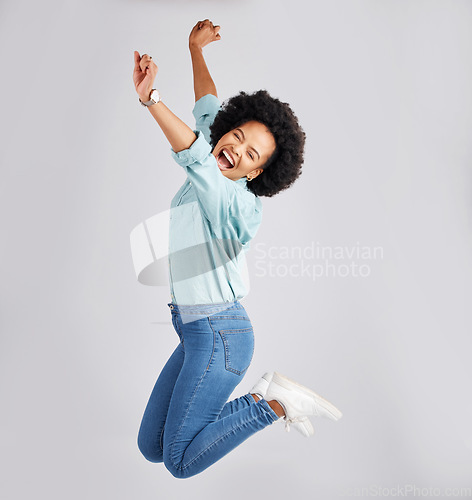 Image of Excited, jump and black woman with success in studio with winning, achievement and celebration for good news. Winner, mockup and isolated girl on white background jumping for prize, promo and bonus