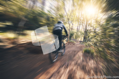 Image of Energy, cycling, and speed with man in nature for training, extreme sports and motion blur. Workout, race and fast with cyclist on bike in forest park for performance, challenge and adventure