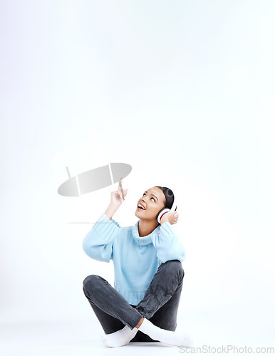 Image of Studio music, relax and woman point at radio sales promotion, advertising space or audio podcast mockup. Marketing commercial, headphones deal and sound streaming female listening on white background