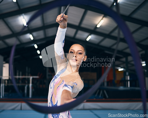 Image of Ribbon, gymnastics and portrait of woman in action, dance performance and sports competition. Female, rhythmic movement and dancing athlete with creative talent, concert event and practice arena