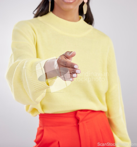 Image of Woman, hand shake with agreement and partnership deal, onboarding and recruitment on studio background. Collaboration, female networking with welcome, offer with thank you or greeting gesture