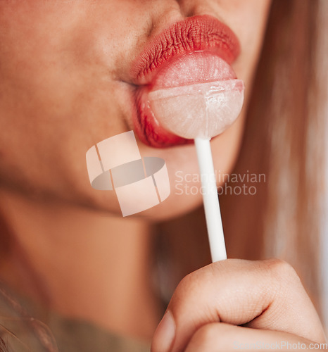 Image of Lollipop, woman and mouth closeup with makeup, cosmetic and beauty while eating sweet candy. Lips, young person and hungry female model with a girl pout with sweets and cosmetics for youth aesthetic