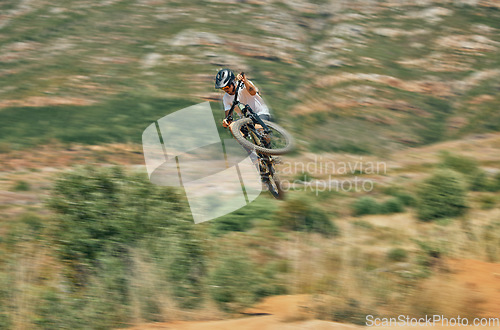 Image of Cycling, jump and mountain bike with man in nature for extreme sports, fitness and adventure. Adrenaline junkie, performance and stunt with athlete riding in outdoors for action, risk and training