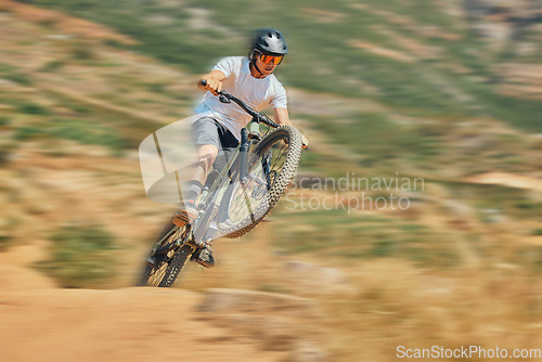 Image of Cycling, jumping and extreme sports with man on mountain bike for adventure, fitness and adrenaline junkie. Exercise, risk and fast with male athlete in nature for workout, training and speed