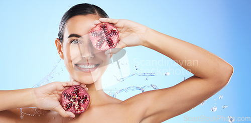 Image of Pomegranate, portrait and water splash of woman, beauty and wellness on blue background banner. Happy model, shower and healthy fruits for natural benefits, detox nutrition and skincare dermatology