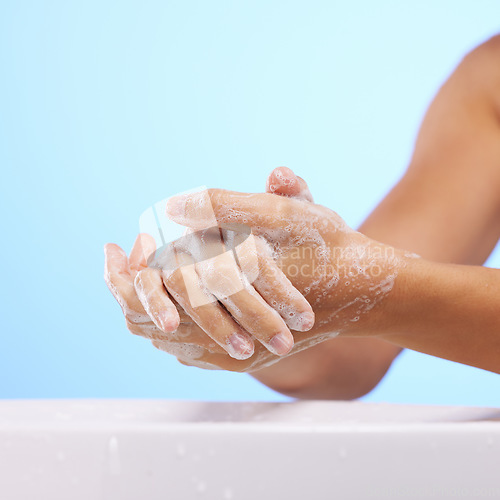 Image of Soap, girl or washing hands in studio on blue background for wellness or healthy skincare hydration. Healthcare mockup, body care zoom or woman cleaning with liquid for hygiene or bacteria prevention