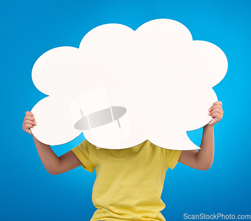 Image of Speech bubble space, thinking and child with idea, opinion and news announcement on blue background studio. Talking, social media mockup and kid with board, poster or cardboard banner for information