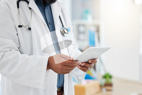 Image of Black man, doctor and hands with tablet in healthcare research, planning or checking schedule appointment at hospital. Hand of African male medical expert working, browsing or search on touchscreen