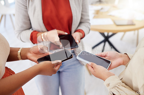 Image of Collaboration, technology and communication with a team of business people in a huddle to share information. Group, data and networking with colleagues standing in a circle in the office at work