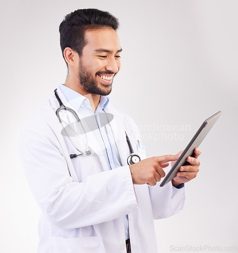 Image of Happy asian man, doctor and tablet in medical research, Telehealth or communication against a white studio background. Male healthcare professional smiling on touchscreen for good health results